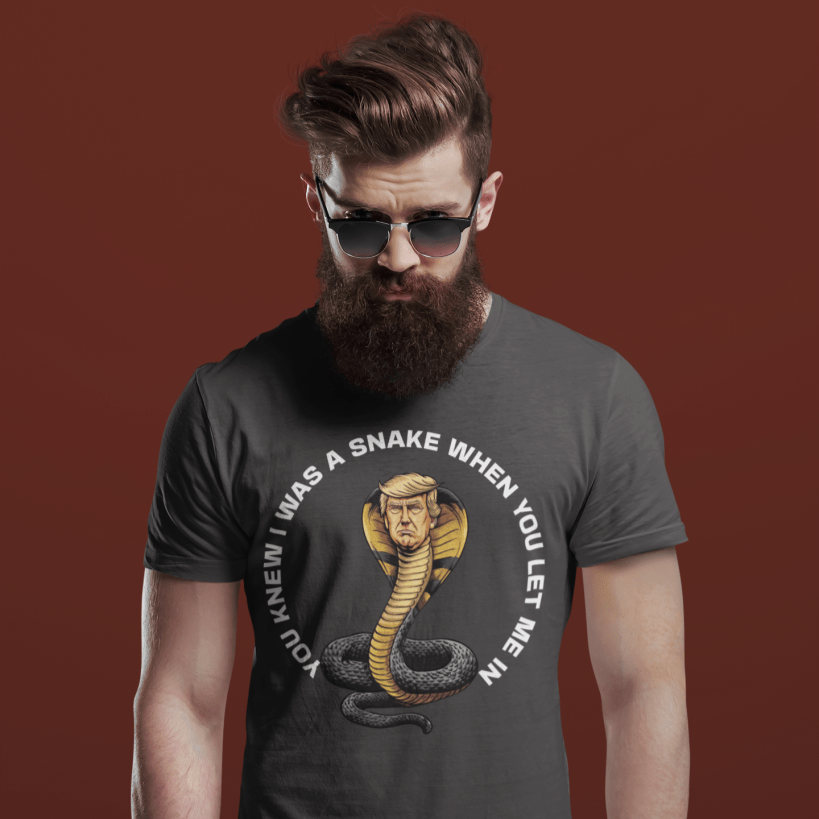Man wearing a dark gray t-shirt with a snake graphic and text on a burgundy background