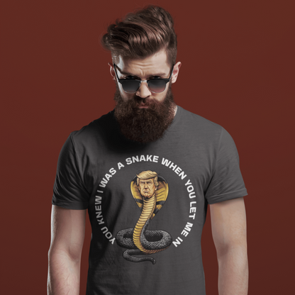 Man wearing a dark gray t-shirt with a snake graphic and text on a burgundy background