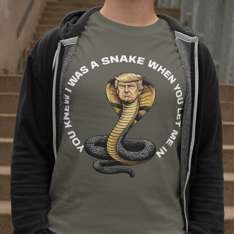 Person wearing a shirt with a graphic of a snake and text, standing on steps.