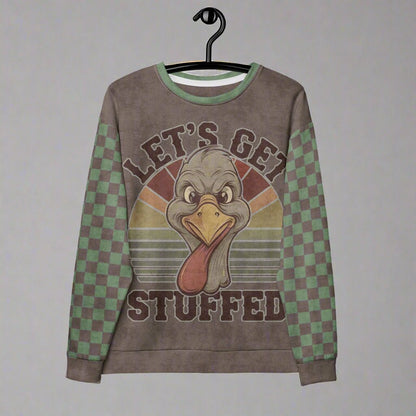 Sweatshirt with a cartoon turkey design and 'Let's Get Stuffed' text on a hanger.