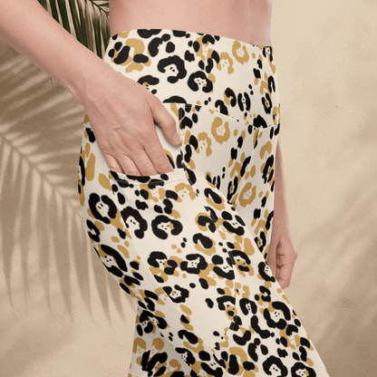 Leopard print pants worn by a person on a beige background