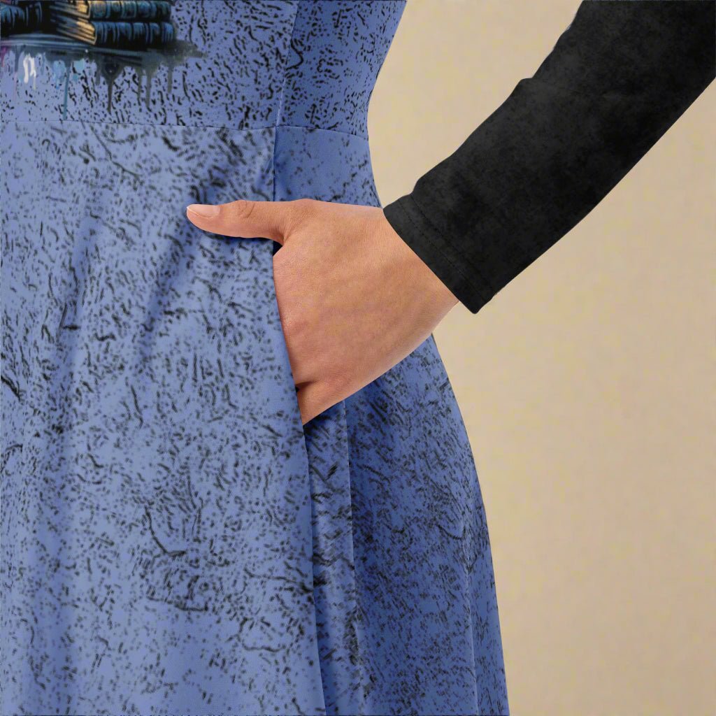Close-up of a textured blue dress with a hand in the pocket on a beige background